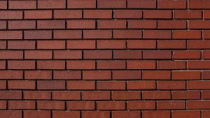 A wall of red bricks with mortar joints