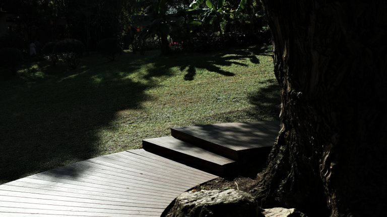 Wooden deck and steps leading to a grassy yard