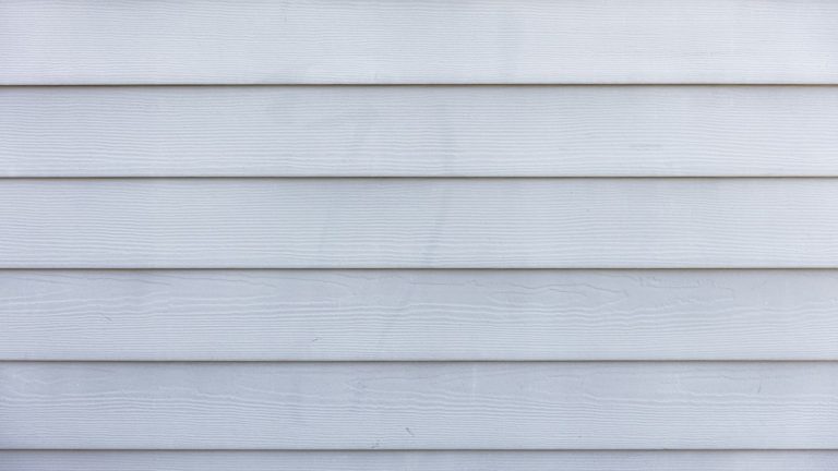 A white painted timber clad wall