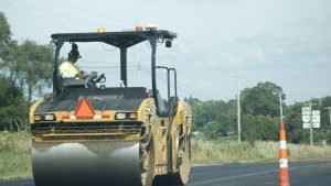 Yellow paving machinery at work on a road