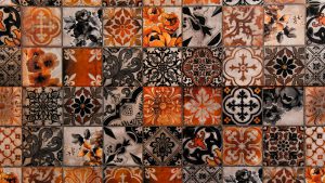 Close up of a patterned tiled wall in orange and black