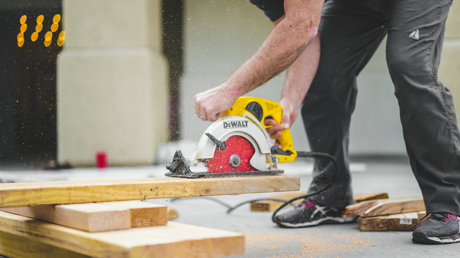 A carpenter cutting timber with a circular saw